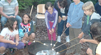 Families_enjoying_snacks_over_the_fire_on_our_bat_and_moth_night_signpost