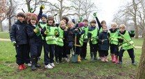 Local_school_children_having_fun_planting_bluebells_in_hyde_park_on_20_march_2013_signpost