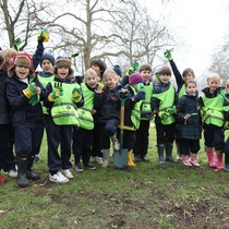 Local_school_children_having_fun_planting_bluebells_in_hyde_park_on_20_march_2013_square
